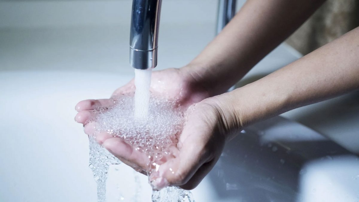 hands being washed with water