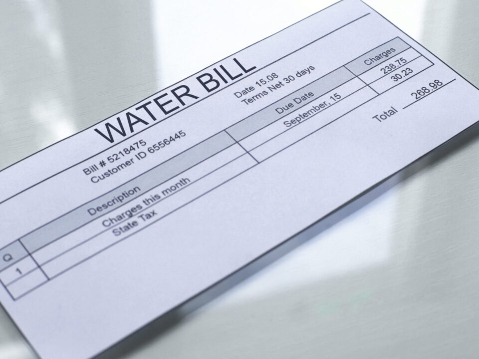 Water bill lying on table, payment for services, month expenses, tariff close up